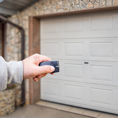 Rochester security key fob pointing to a garage door
